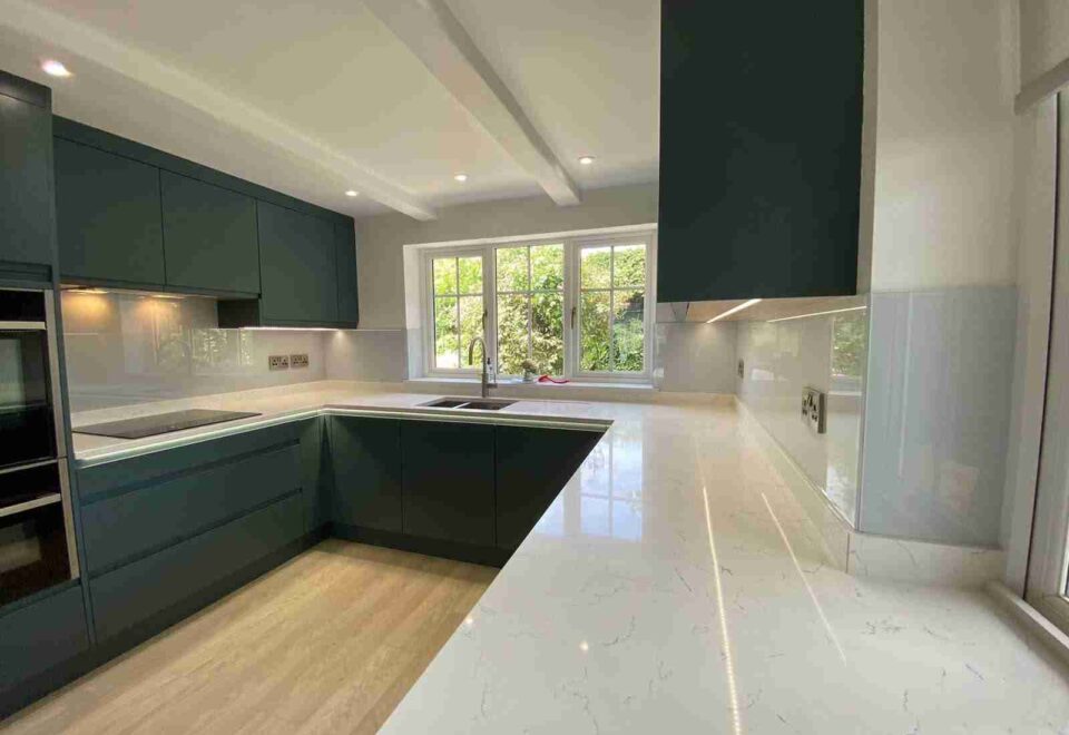 Kitchen with neutral colored glass splashbacks all around in the South West.